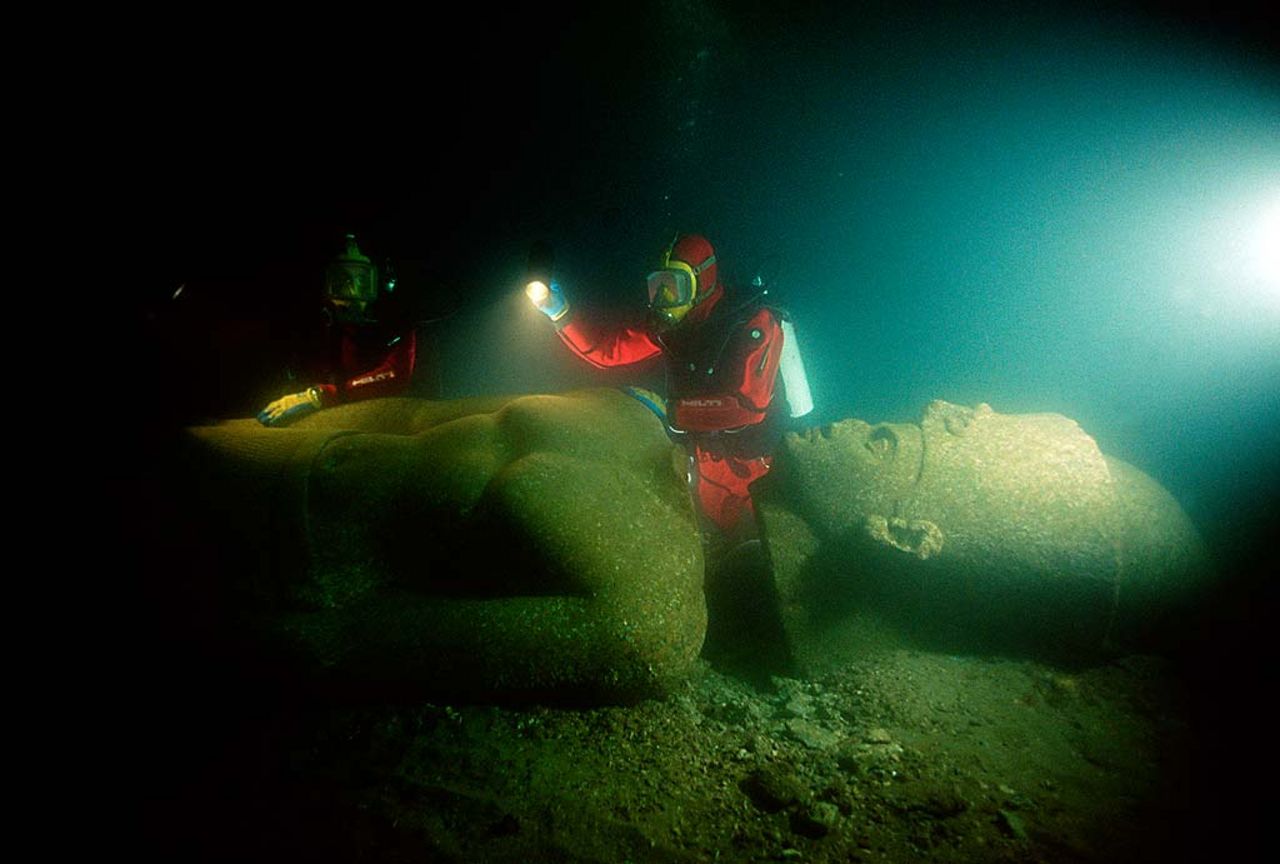 A red granite colossal statue of a Ptolemaic king of over 5 metres height, reassembled underwater after excavation and preliminary cleaning. It was found shattered into 5 fragments close to the main temple in the sunken city of Thonis-Heracleion.