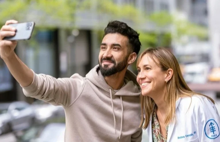 Imtiaz Hussain takes a selfie with his MSK medical oncologist, Andrea Cercek.  He says that when he was told the immunotherapy was successful, “the first thing I did was call my mom. We both cried.”