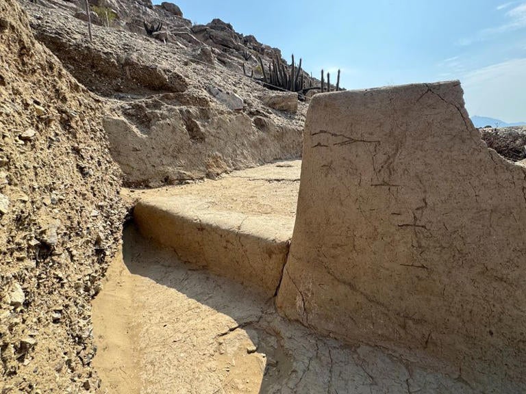 Pieces of what appear to be parts of a 4,000-year-old ceremonial temple buried in a sand dune of northern Peru