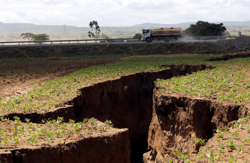 A tanker drives near a chasm suspected to have been caused by a heavy downpour along an underground fault-line near the Rift Valley town of Mai-Mahiu. 