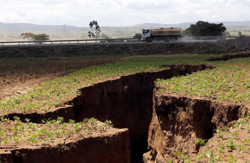A tanker drives near a chasm suspected to have been caused by a heavy downpour along an underground fault-line near the Rift Valley town of Mai-Mahiu. 