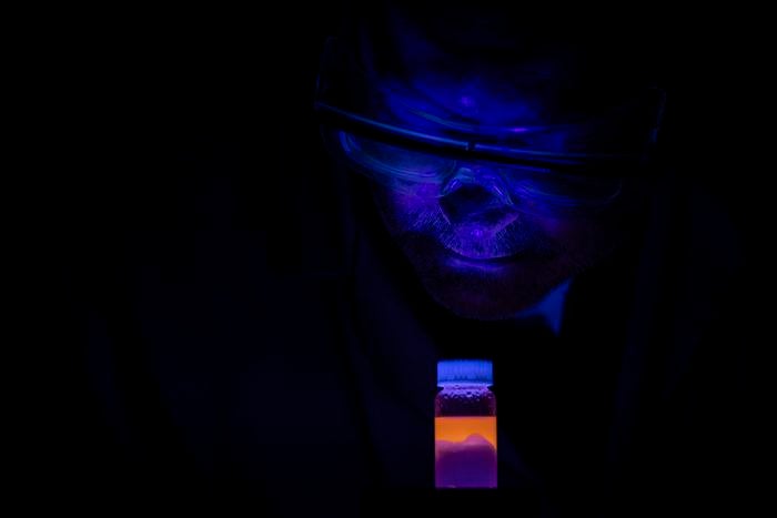 Gary Baker, an associate professor in the University of Missouri’s Department of Chemistry, looks at a bottle of a new liquid-based solution that eliminates more than 98% of microscopic plastic particles from water.

