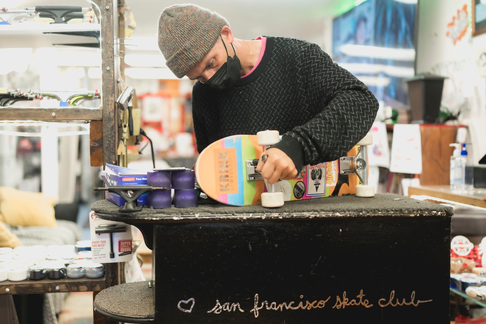 Shawn Connolly installs new trucks on a customer's skateboard. Located on Divisidero St, SF Skate Club serves as a retail shop, meeting space, education center, and a haven for community youth.