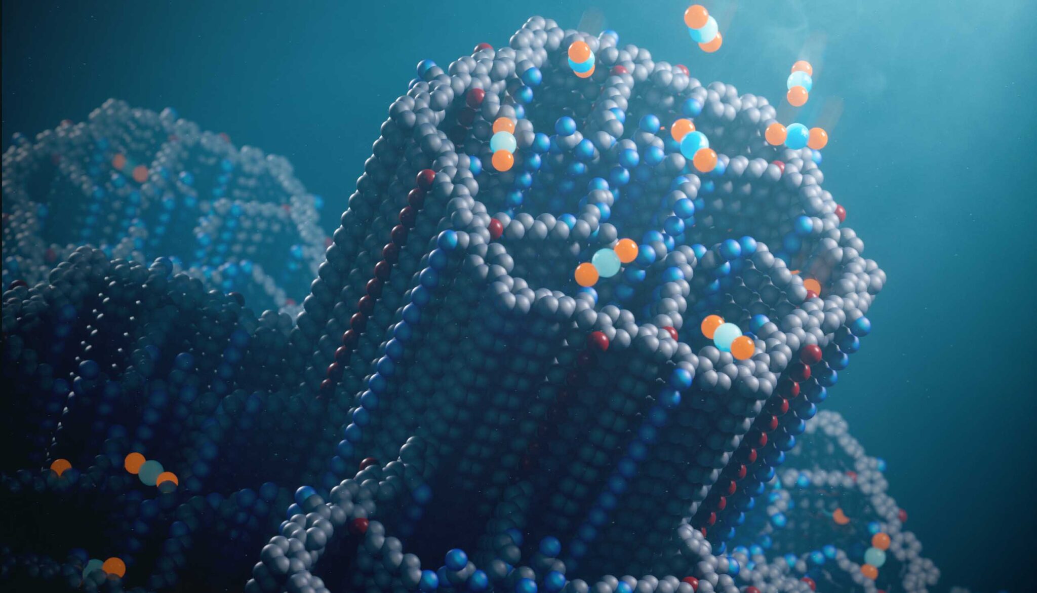 The new porous material for capturing carbon dioxide, called a covalent organic framework (COF), has hexagonal channels decorated with polyamines that efficiently bind carbon dioxide molecules (blue and orange balls) at concentrations found in ambient air. 