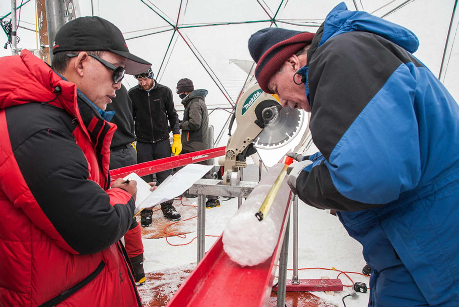 Lonnie G. Thompson (right) and Tandong Yao (left) measuring the Guliya ice core section.