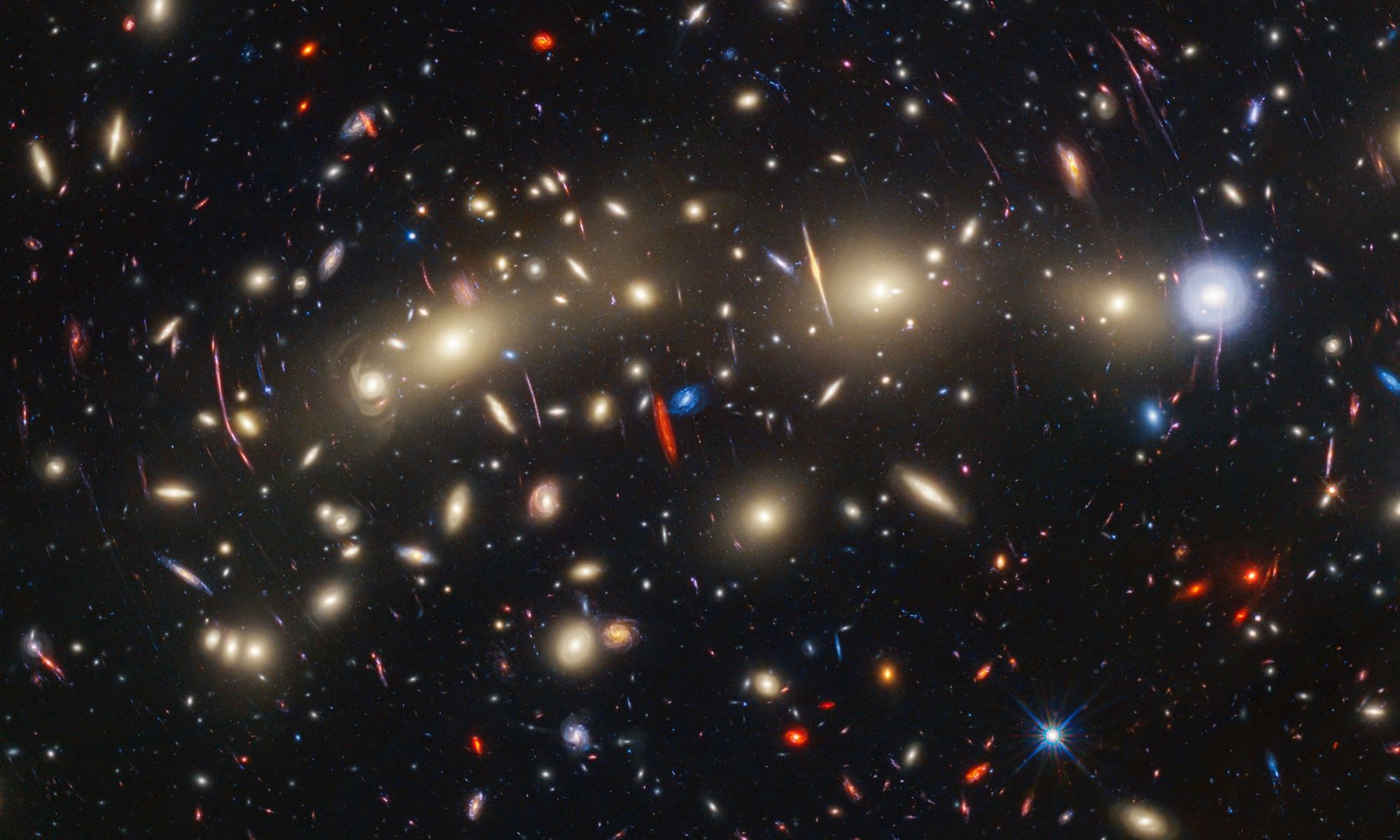 Panchromatic view of galaxy cluster MACS0416 was created by combining infrared observations from the NASA/ESA/CSA James Webb Space Telescope with visible-light data from the NASA/ESA Hubble Space Telescope.