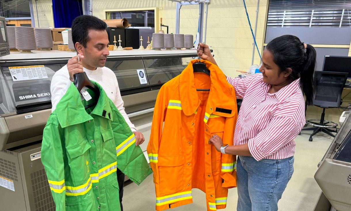 Dr Chamila Gunasekara (left) and PhD scholar Nayanatara Ruppegoda Gamage with discarded firefighting clothes that could be used to make crack-resistant, stronger concrete. 
