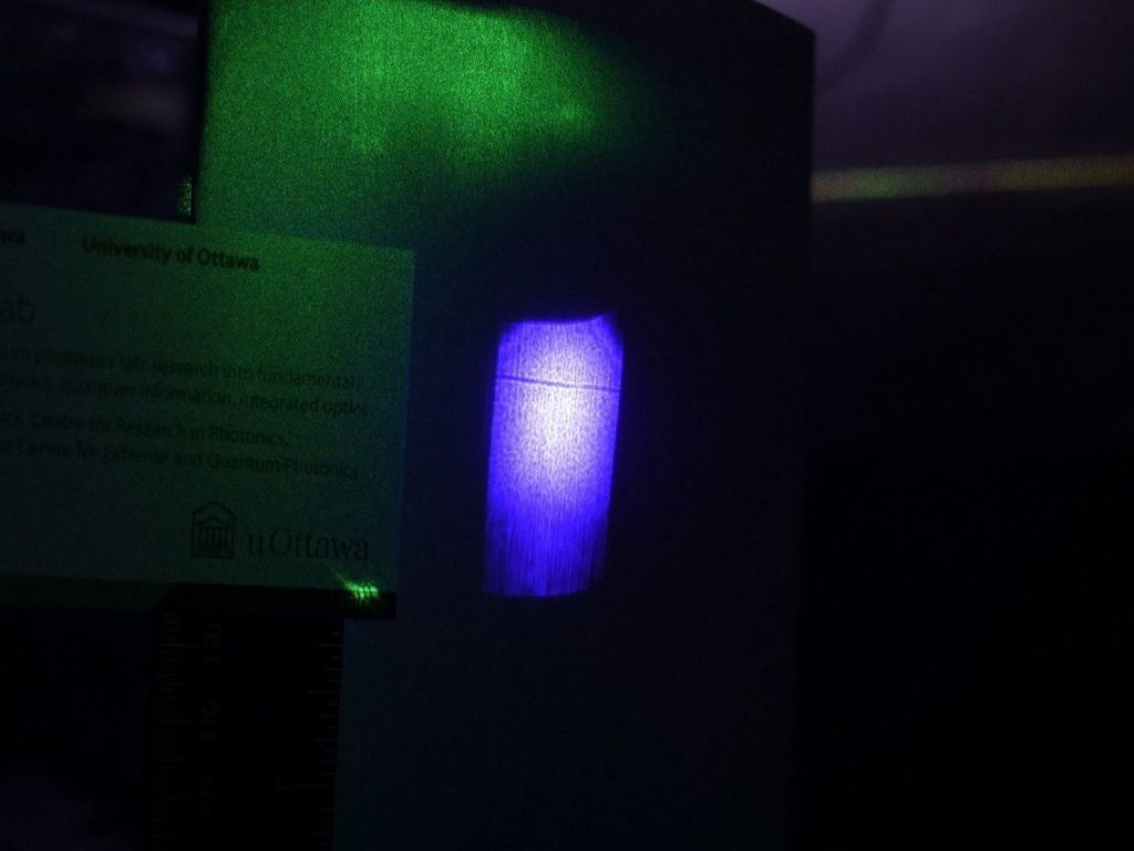 Researchers showed that a laser beam can sometimes act like a solid object and cast a shadow that is visible to the naked eye. In the picture, the shadow appears as the horizontal line traversing the blue background. 