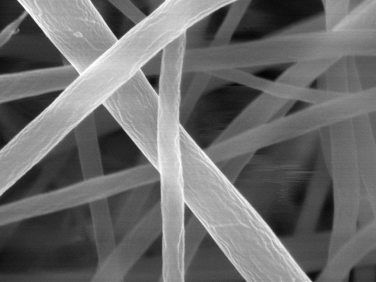 The team used a scanning electron microscope, scanning the mat with a focused beam of electrons and creating an image based on the pattern of electrons that are deflected or knocked-off. Each individual strand is too narrow to be clearly captured by any form of visible light camera or microscope.
