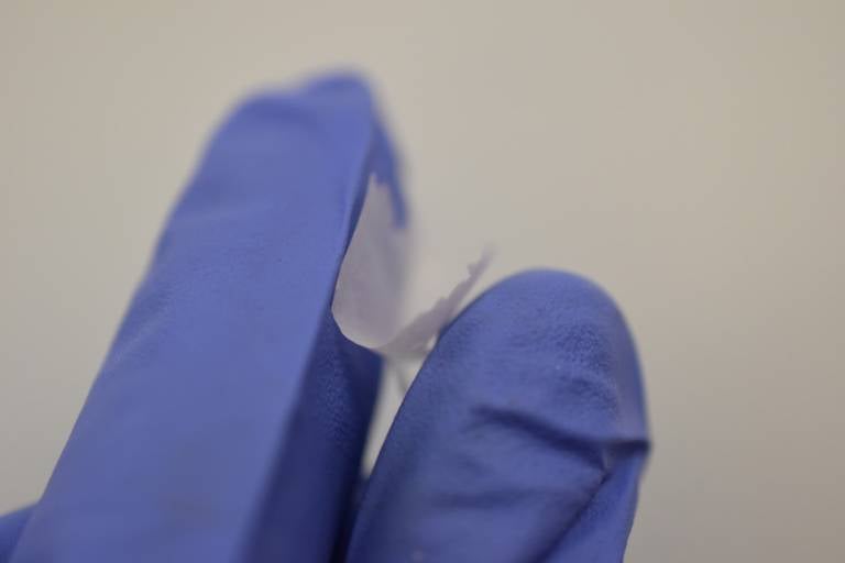 The nanofiber mat held between two fingers.