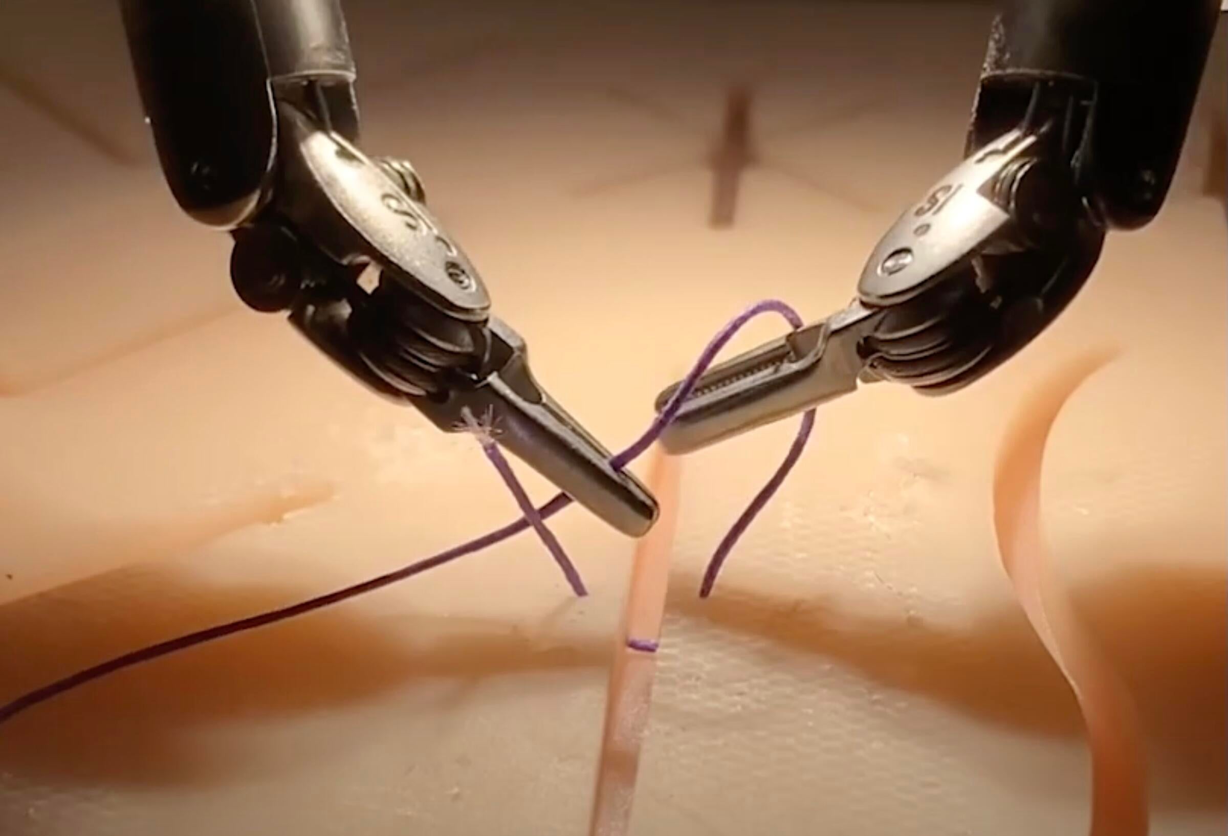 daVinci robot threading a surgical stitch. 