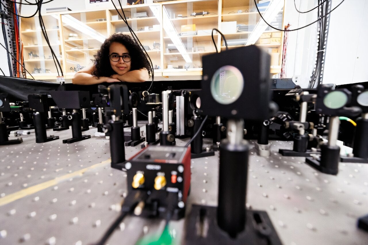 Experimental physicist Daniela Angulo poses with an apparatus in the physics lab at the University of Toronto. 