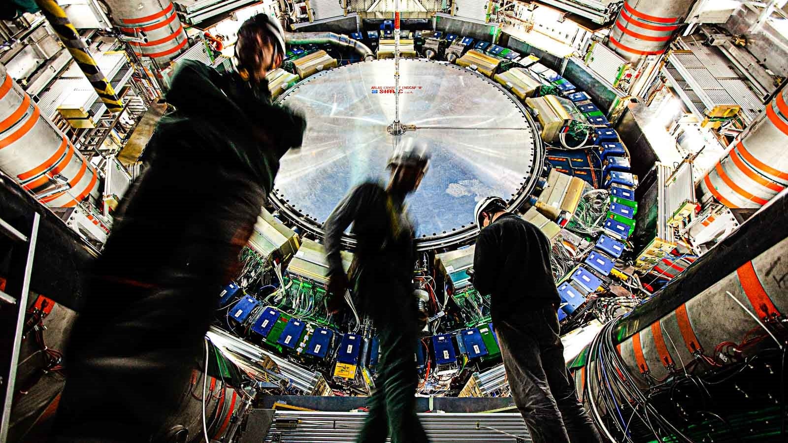 Workers inside ATLAS, one of several primary detectors for the Large Hadron Collider at CERN. 