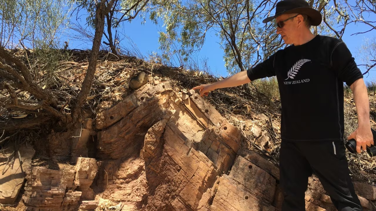 Professor Dietmar Müller points to carbonates overlying the Sturt Formation in the Flinders Ranges. 