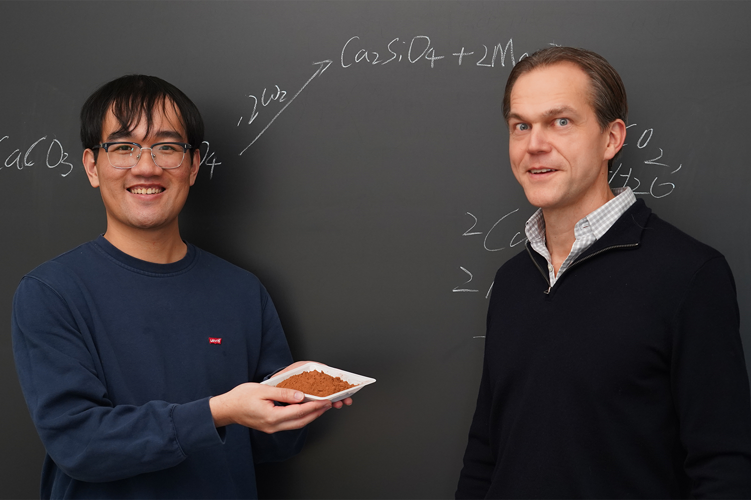 Postdoctoral scholar Yuxuan Chen, left, holds some carbon dioxide-trapping material with Matt Kanan in their laboratory.
