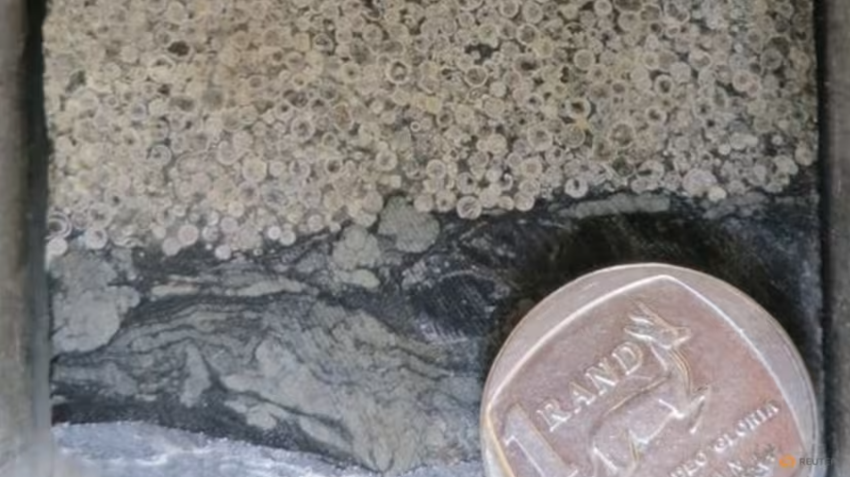 Tiny, round rock fragments known as spherules—created by the intense heat and pressure of a meteorite impact—have been found embedded in ancient rock layers of the Barberton Greenstone Belt in northeastern South Africa.
