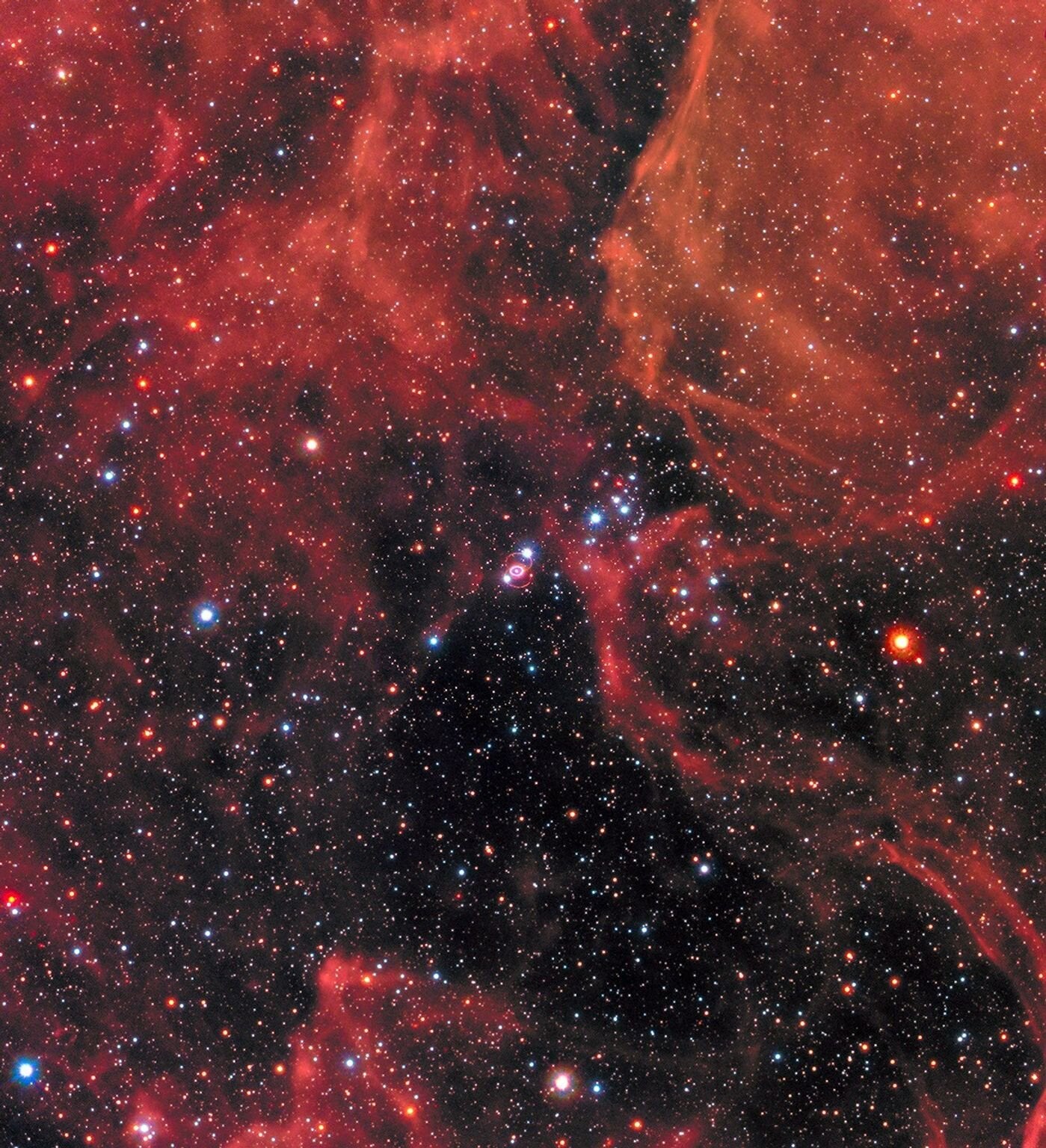 Pictured is an example of one of these stellar explosions, Supernova 1987a (center), within a neighboring galaxy to our Milky Way called the Large Magellanic Cloud. 