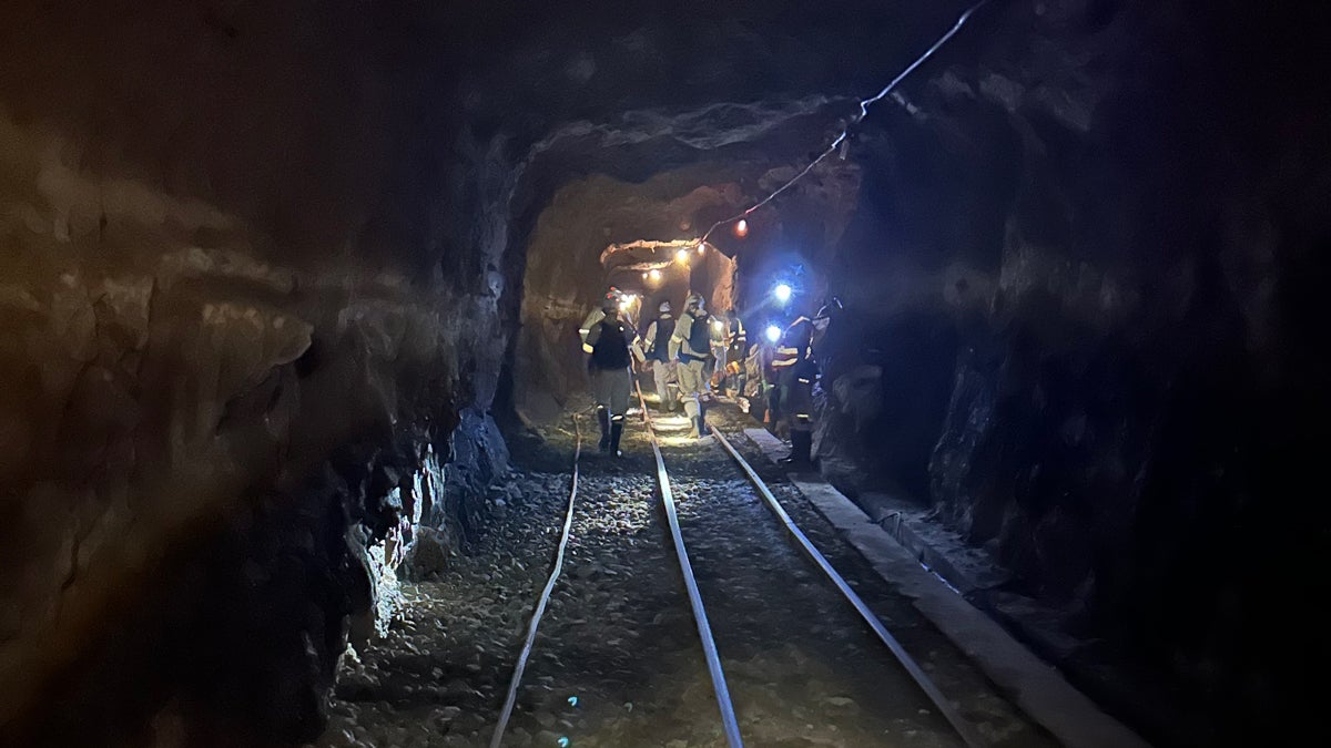 A team of geomicrobiologists walking to a sampling site at the end of an inactive tunnel in a South African gold mine. At this site almost 3 km deep beneath the surface, the researchers can access one of the deepest and oldest ecosystems on Earth. The brines in which these microbes live have been trapped in the rock for more than 1 billion years.