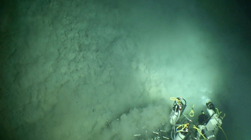 A mud volcano at the seafloor where methane-rich fluids from the subsurface are emitted to the water column. These ecosystems are at the interface between the subsurface and surface realms and are often oases of life in the deep ocean. 