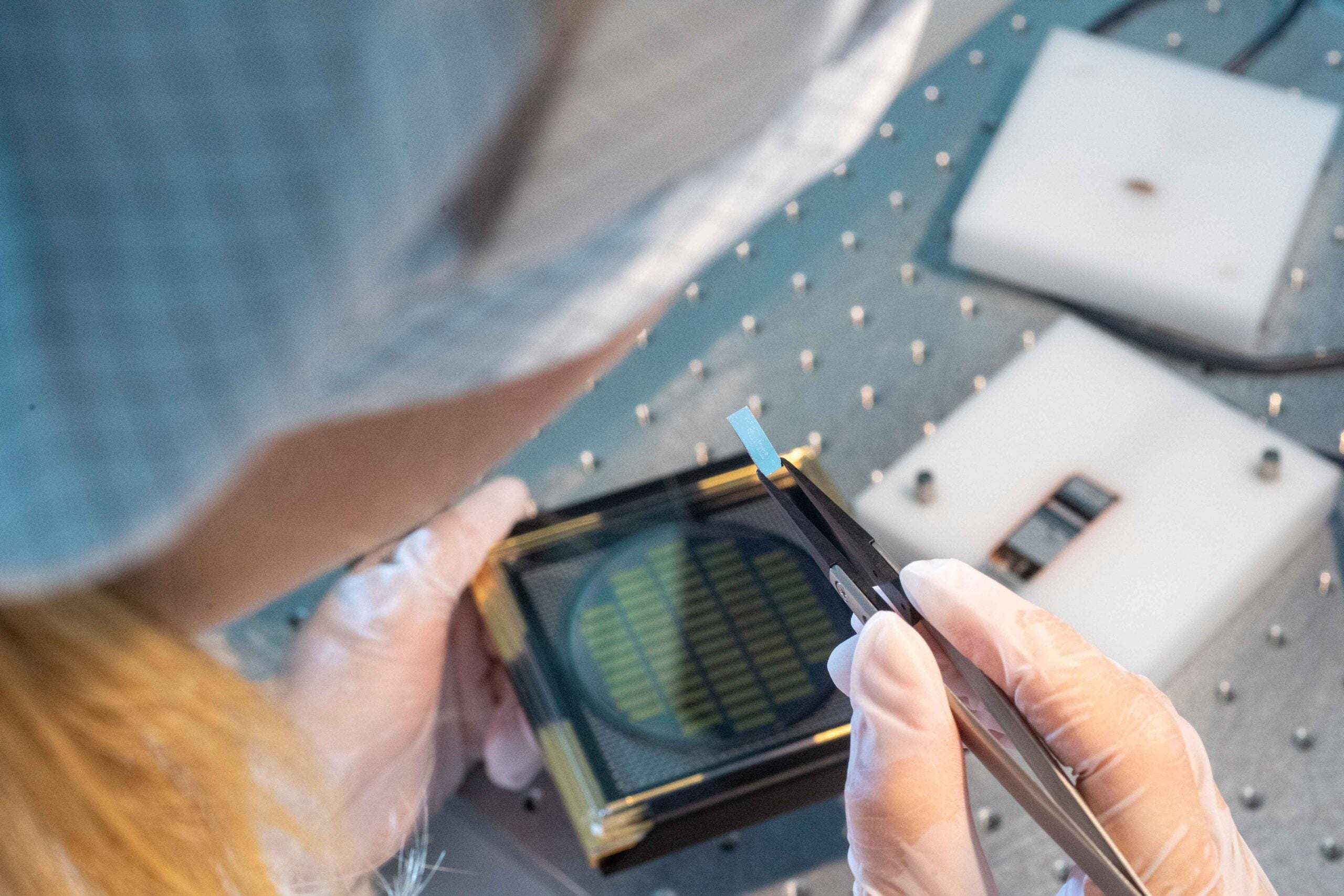 A Q.ANT engineer prepares a photonic chip for the next step in the process.