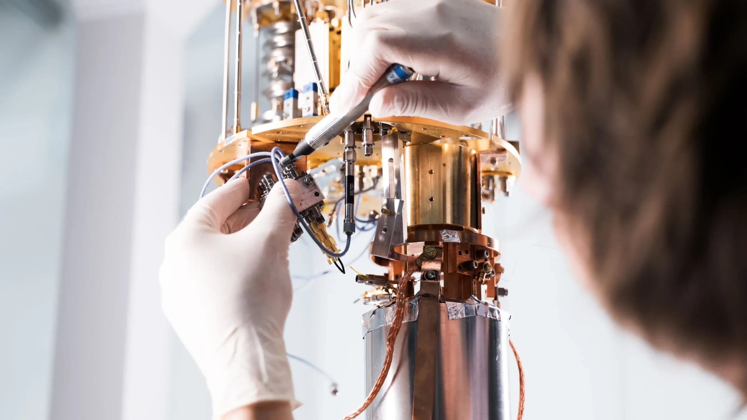 The physicist prepares the experiment in a helium-cooled cryostat.