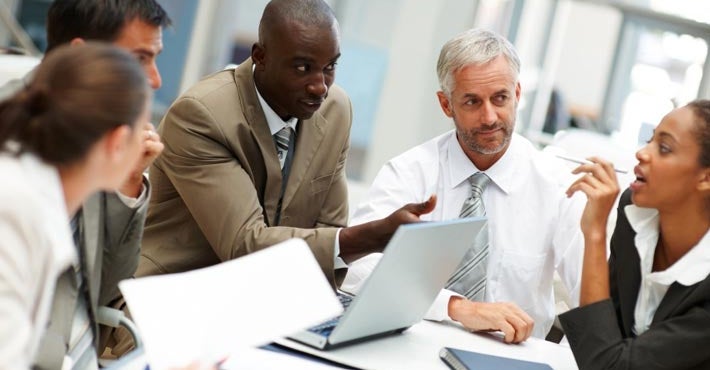 CIOs and business leaders collaborate, sharing knowledge to bridge gaps and align technology goals with company success.