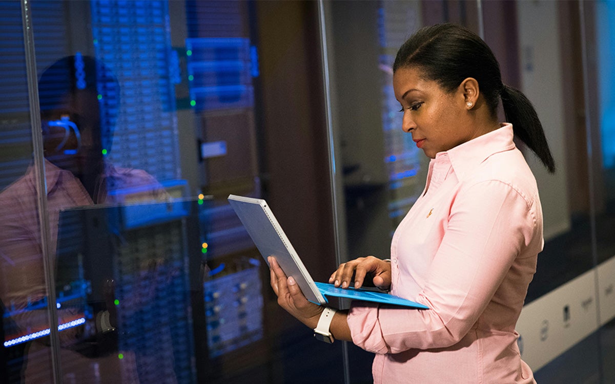 An IT specialist monitors systems, showing how technical expertise supports strong collaboration and drives business success through technology.