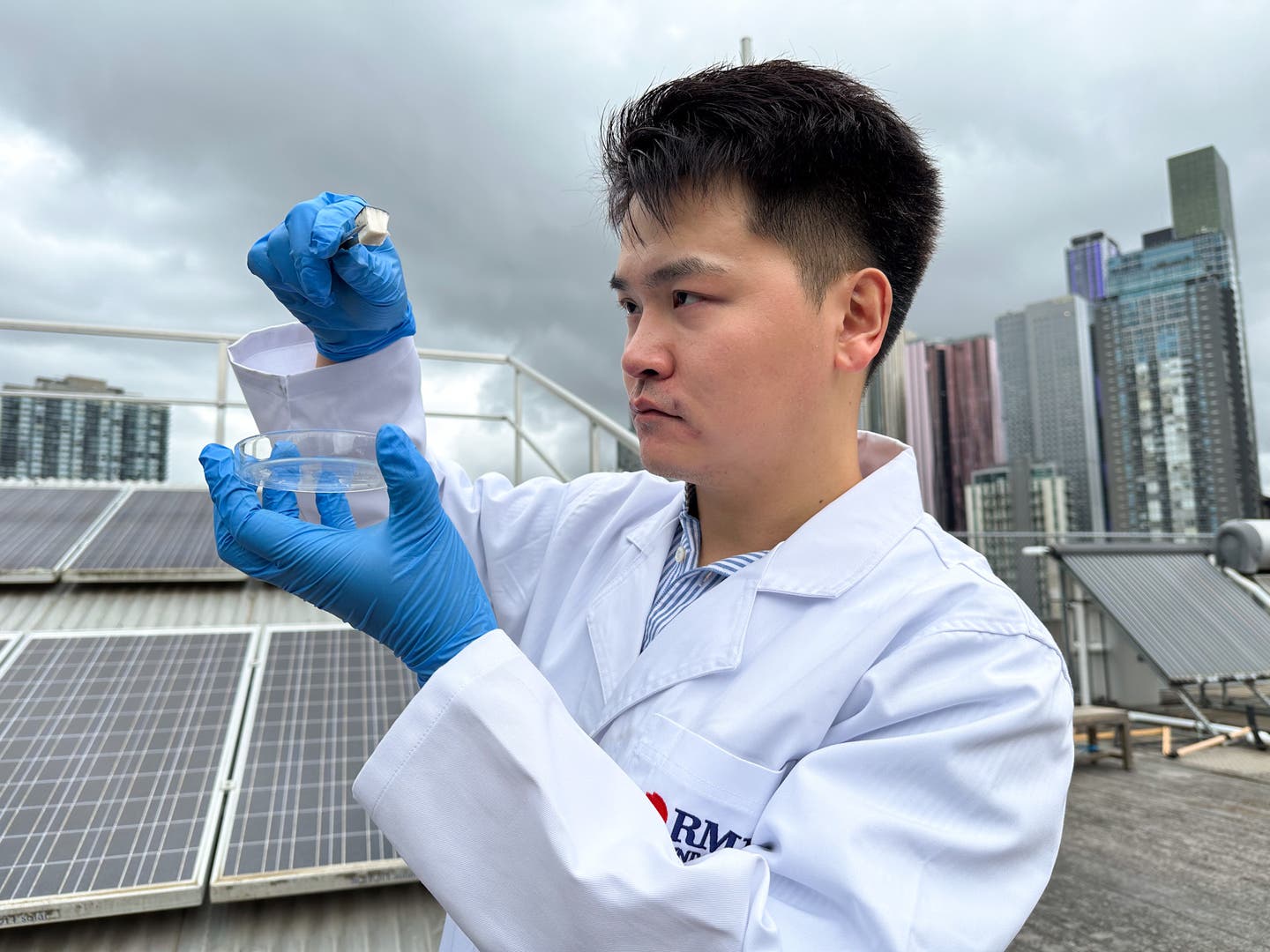 Dr Derek Hao, from RMIT University, holds the team’s spongy wood-based composite material that can absorb water from the atmosphere.