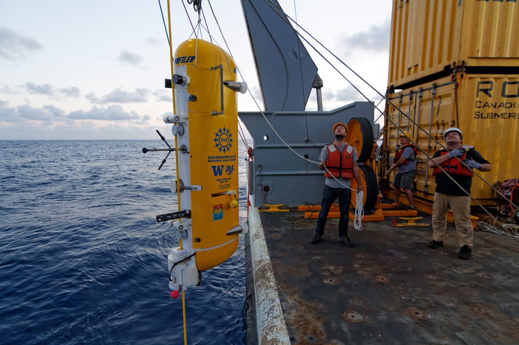 Researchers prepare to install a multi-instrument vehicle known as a deep profiler on the Regional Cabled Array.