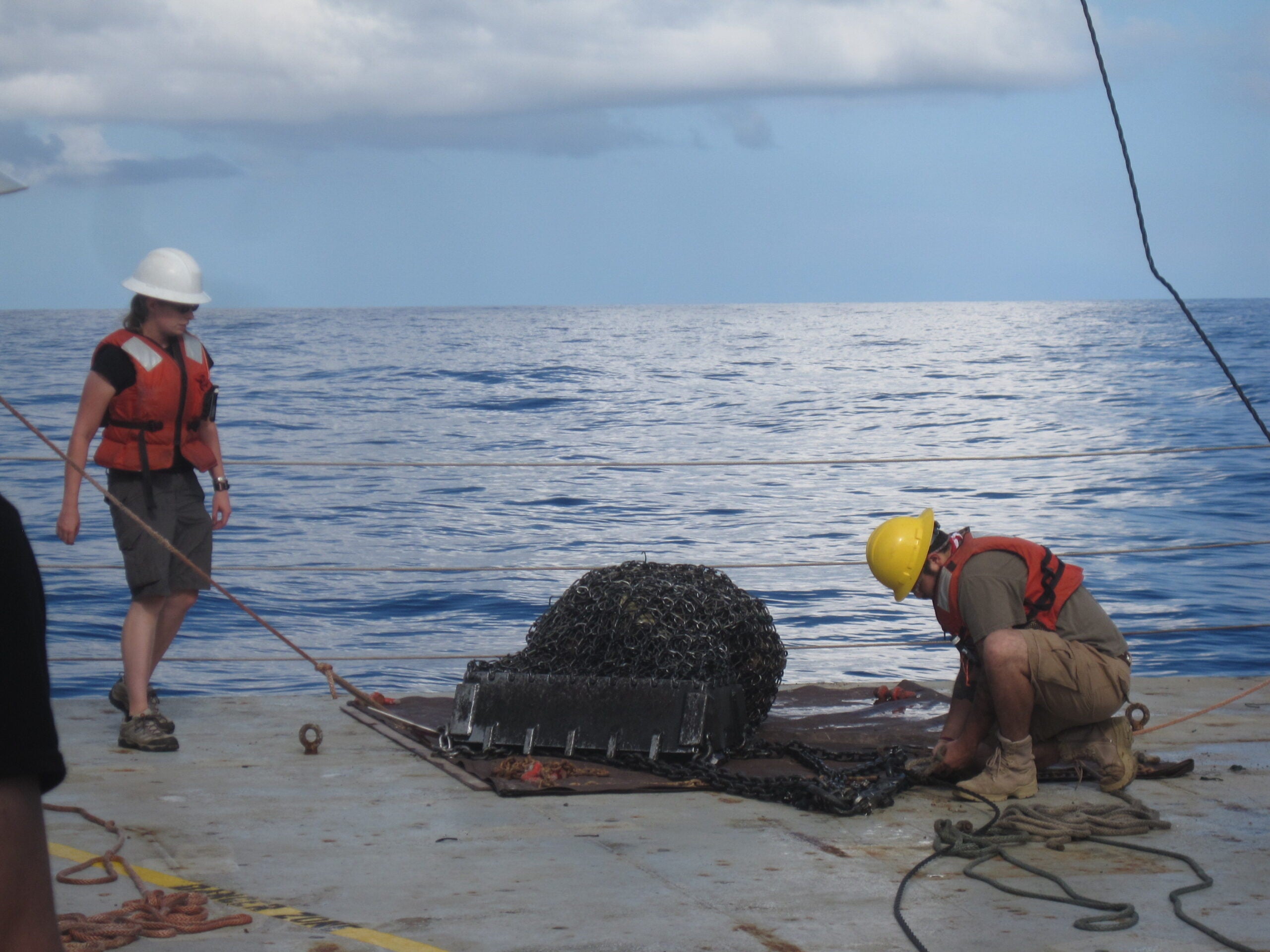 Val Finlayson (left) and Paulo Galvan recovering rock samples from a dredge from a 2013 expedition.