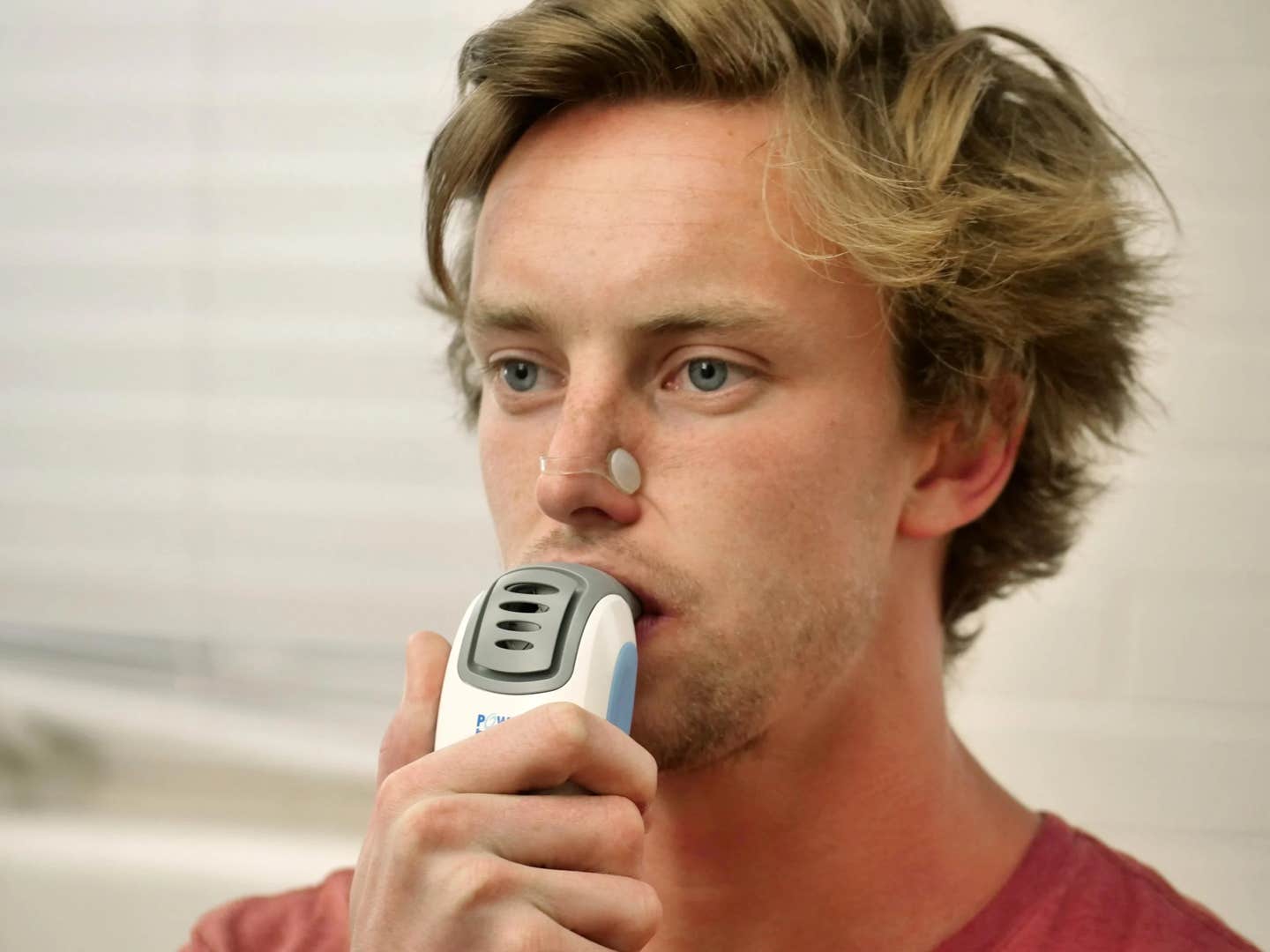 Tom Heinbockel, a master's student in integrative physiology at the University of Colorado Boulder, shows how to use a Power Breathe device during a lab session.