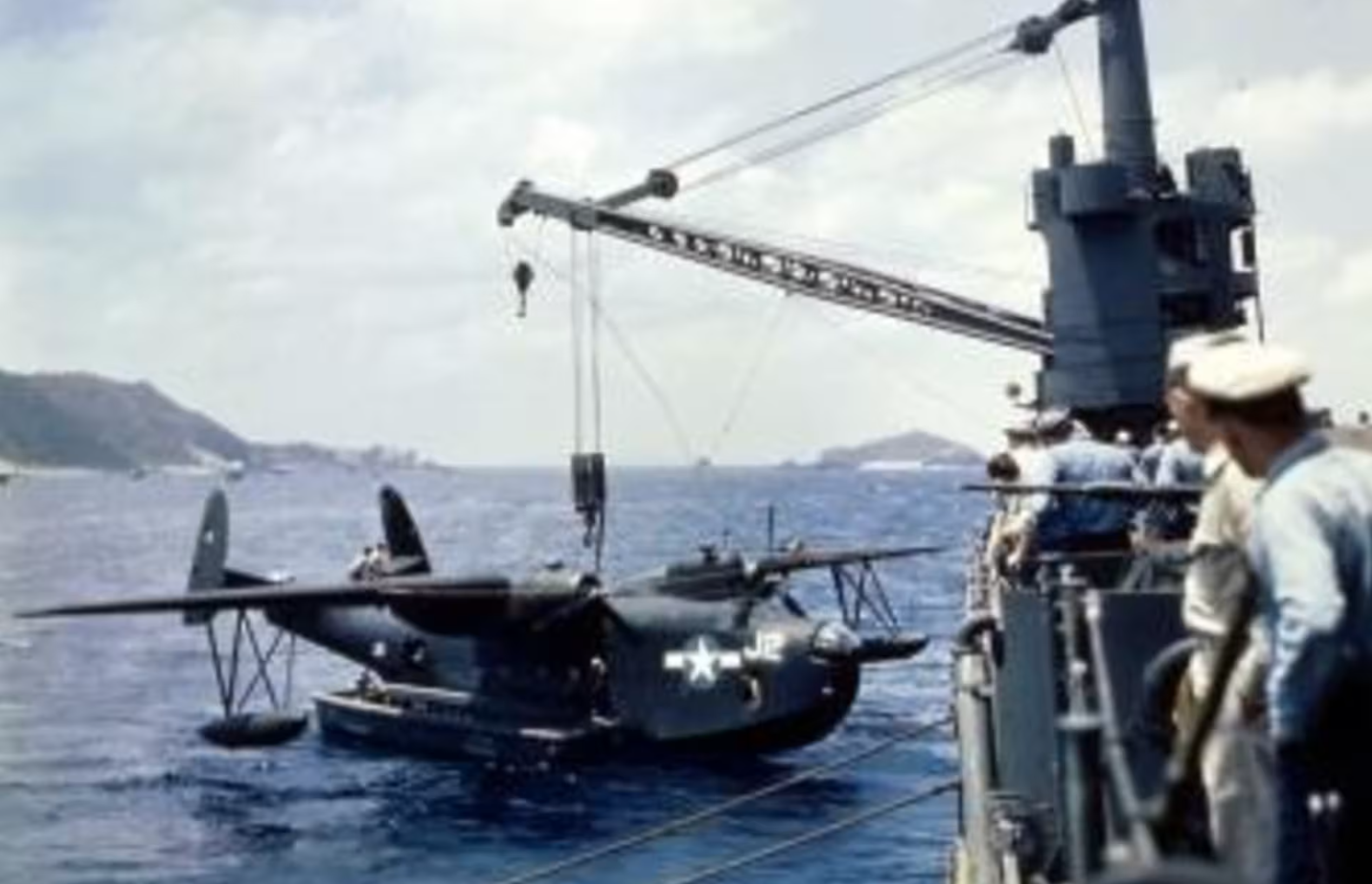 A Martin PBM Mariner suspended from a ship’s stern crane. 