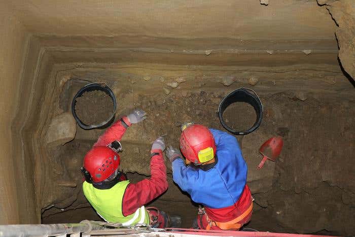 Team excavators in cave