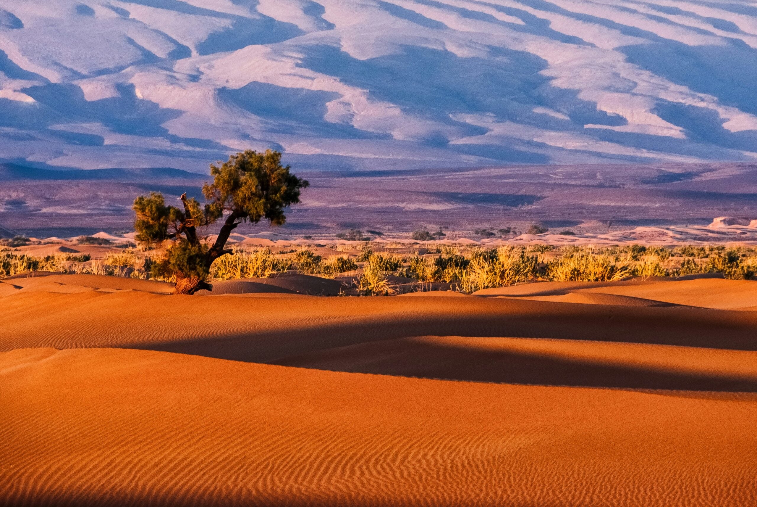 In desert regions like the Sahara, there are fewer clouds to begin with.