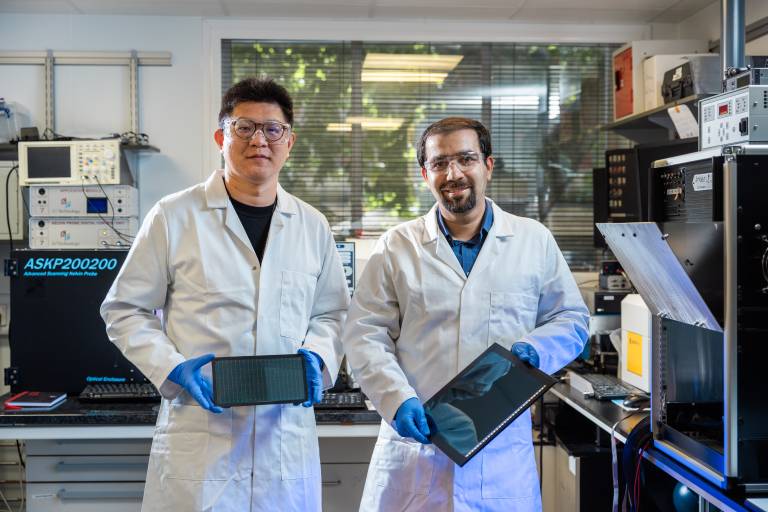 Associate Professor Mojtaba Abdi-Jalebi and PhD candidate Siming Huang with panels of their solar cells optimized for indoor light.