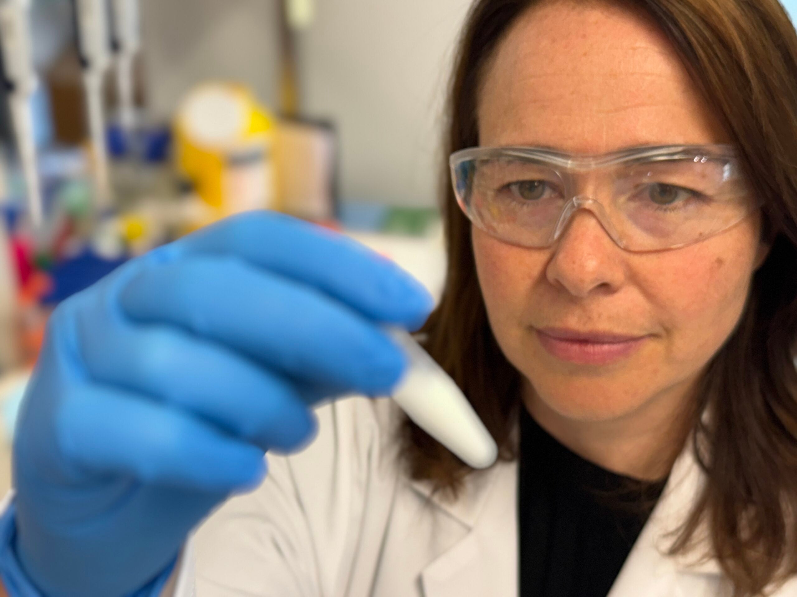 Professor Charlotte Conn with a vial of the cubosome formulation developed to deliver compounds safely to the back of the eye.