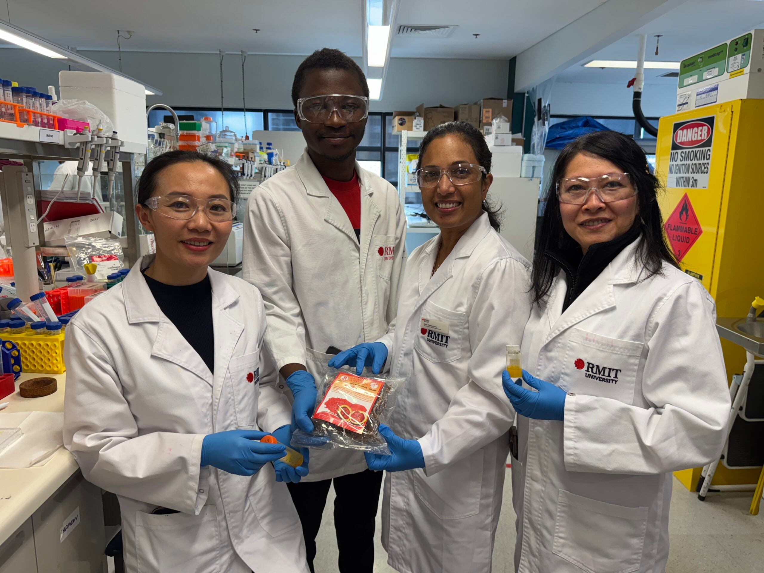 RMIT researchers with Gac fruit extract, the source of lutein for their eyedrop formula: (left to right) Dr Dao Nguyen, Christopher Olowosoke, Dr Thilini Thrimawithana and Associate Professor Tien Huynh.