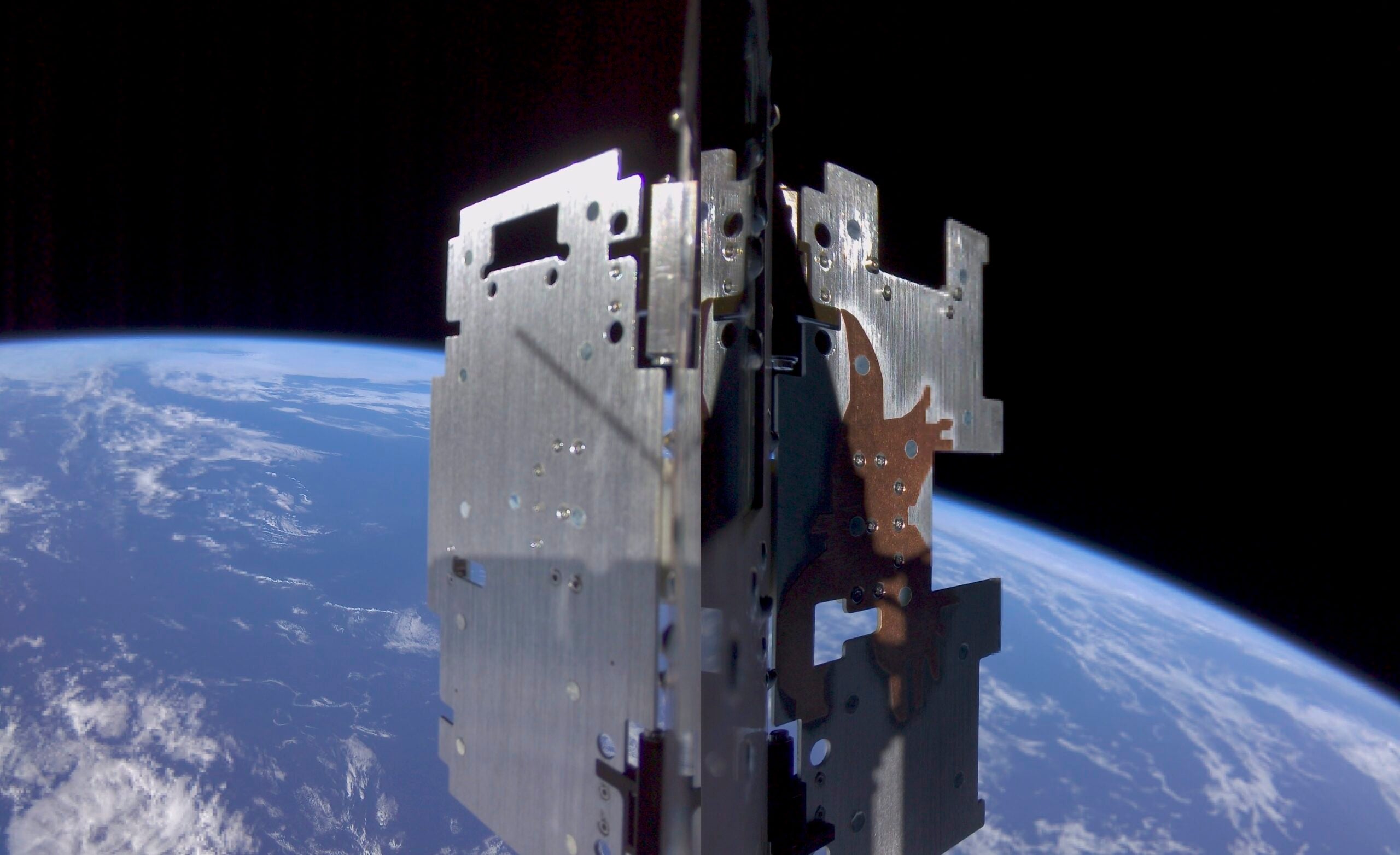 SpIRIT’s radiators after deployment, flying high over the Indian Ocean. The “Eagle”, a copper structure on the right radiator can be seen, which is designed to help dissipate heat from SpIRIT’s thermal management system.