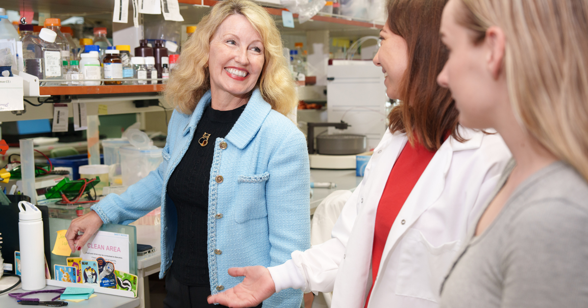 Catriona Jamieson, M.D., Ph.D., discussing the mission to the International Space Station with members of her team. 