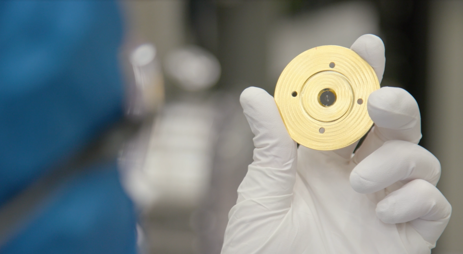 Courtney Sovinec examines the multi-patterned target used to create a new type of X-ray image at Sandia National Laboratories.