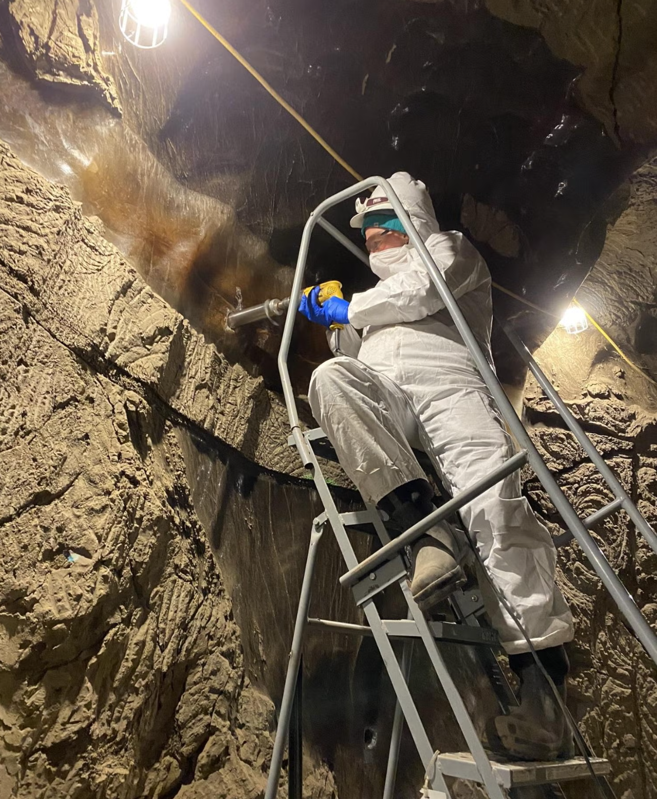 Robyn Barbato of the Cold Regions Research and Engineering Laboratory drills a sample from the walls of the Permafrost Tunnel.