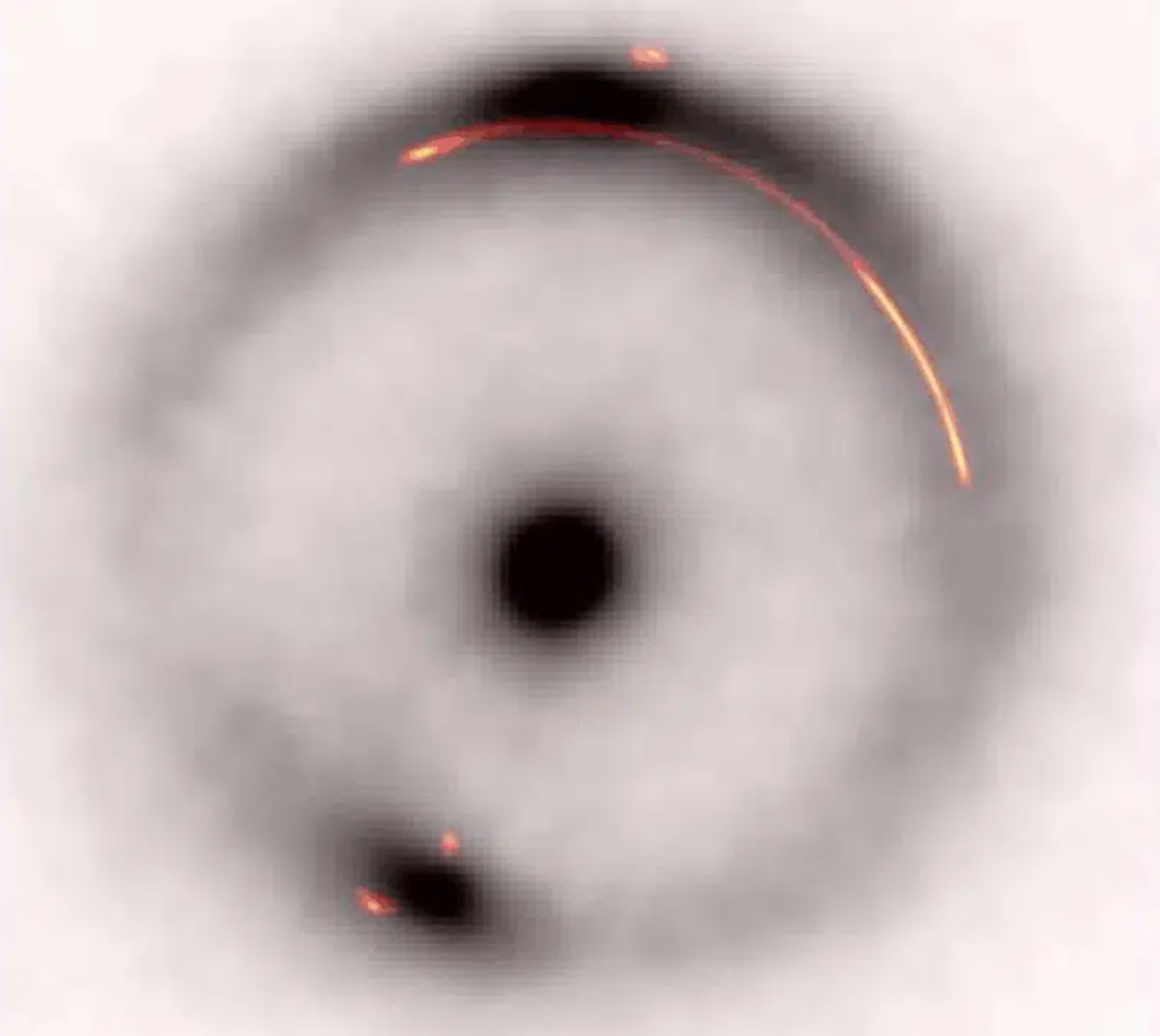 The black ring and central dot show infrared image of a distant galaxy distorted by a gravitation lens.