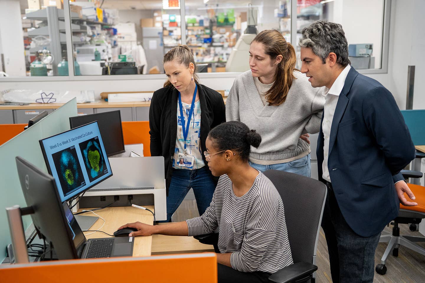 Elias Sayour (right) and lab members review research data.