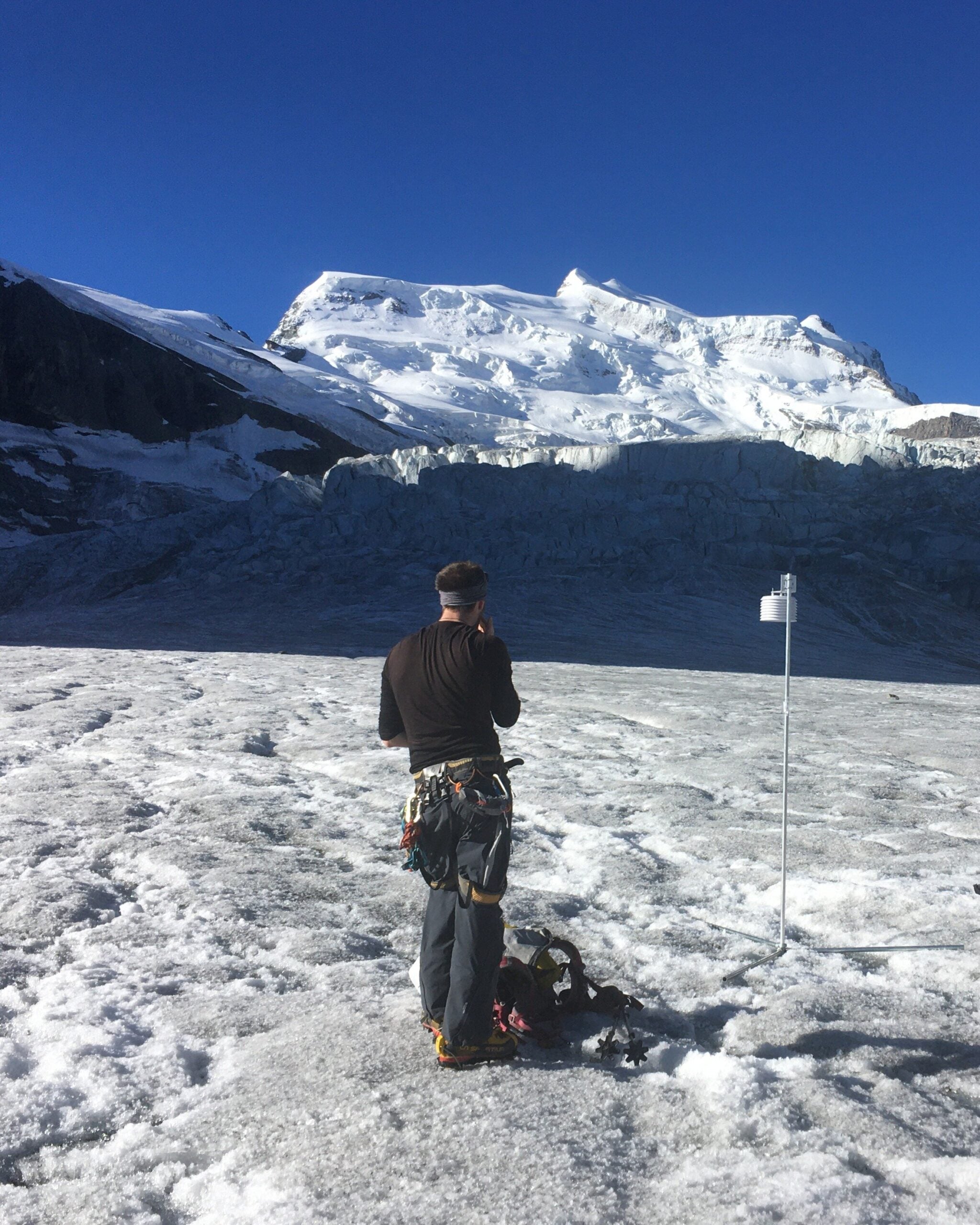 Installing a station on the Glacier de Corbassière, Swiss Alps. ISTA researcher Thomas Shaw looking upward to the Grand Combin. 