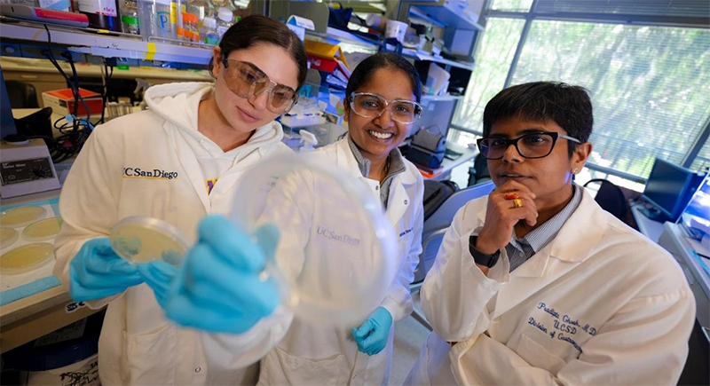 Co-first author Mahitha Shree Anandachar (center), a Ph.D. student in Biomedical Sciences at UC San Diego, with student research assistant Jasmin Salem (left) and Pradipta Ghosh, M.D. (right). 