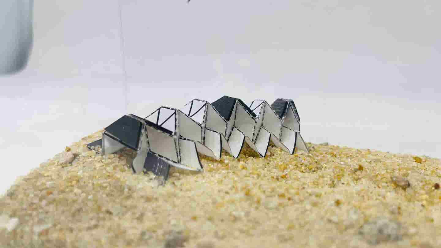 A soft crawling robot designed using the Miura-Ori origami pattern moves through the action of thin magnetic rubber films embedded in its darker sections.