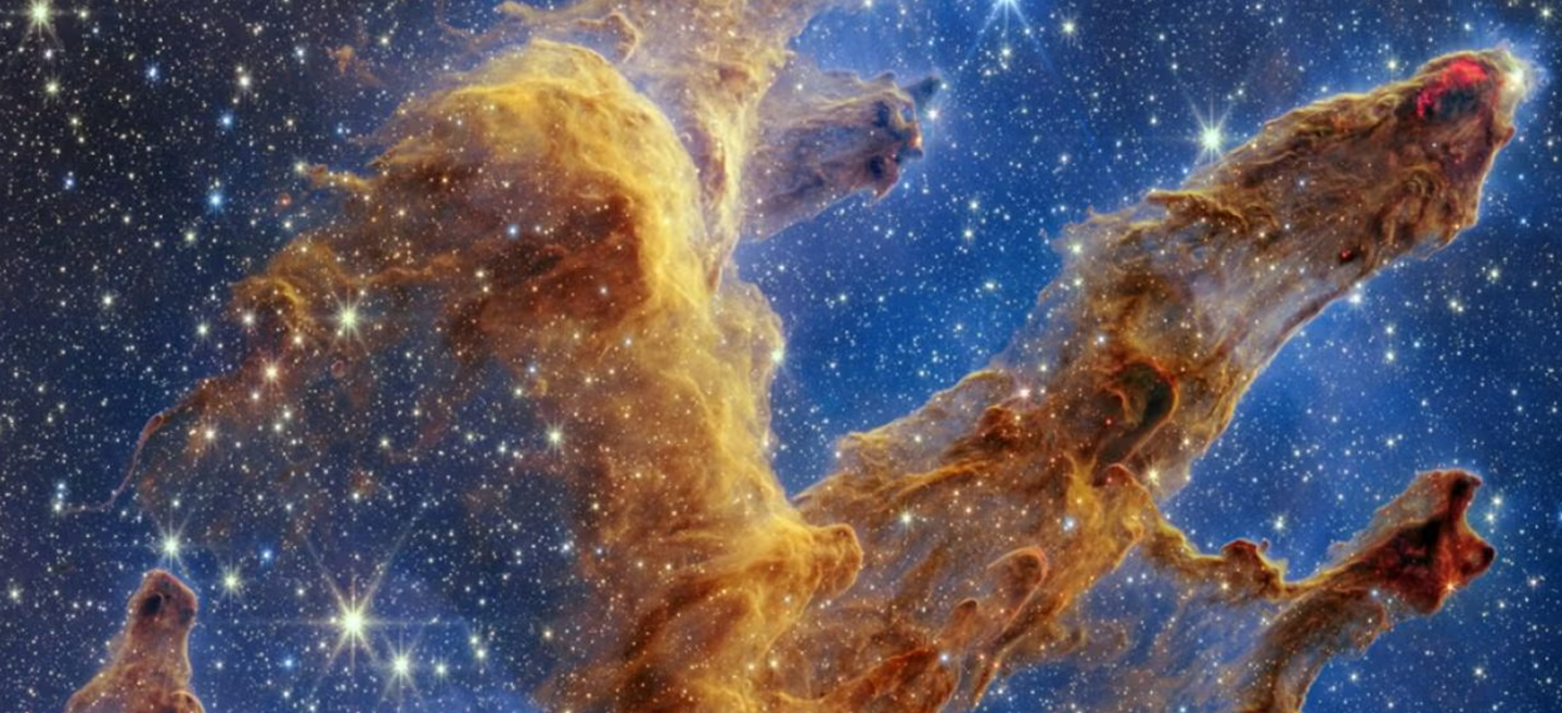 "Pillars of Creation," a region in the Eagle Nebula where clouds of gas and dust are collapsing to form new stars.