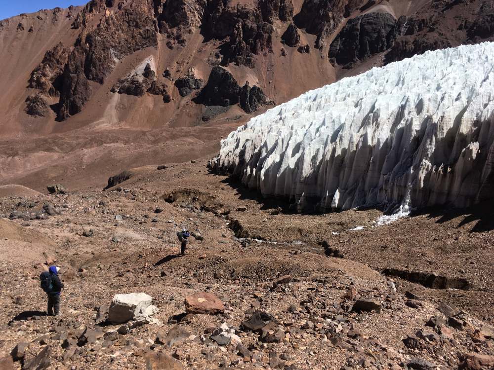 Tapado Glacier, an example of a glacier in the arid landscape of the Southern Andes, Chile. The sharp spikes of snow and ice are typical of dry mountain regions. Meltwater streams pour from the glacier. This type of meltwater is crucially important to the population during droughts.