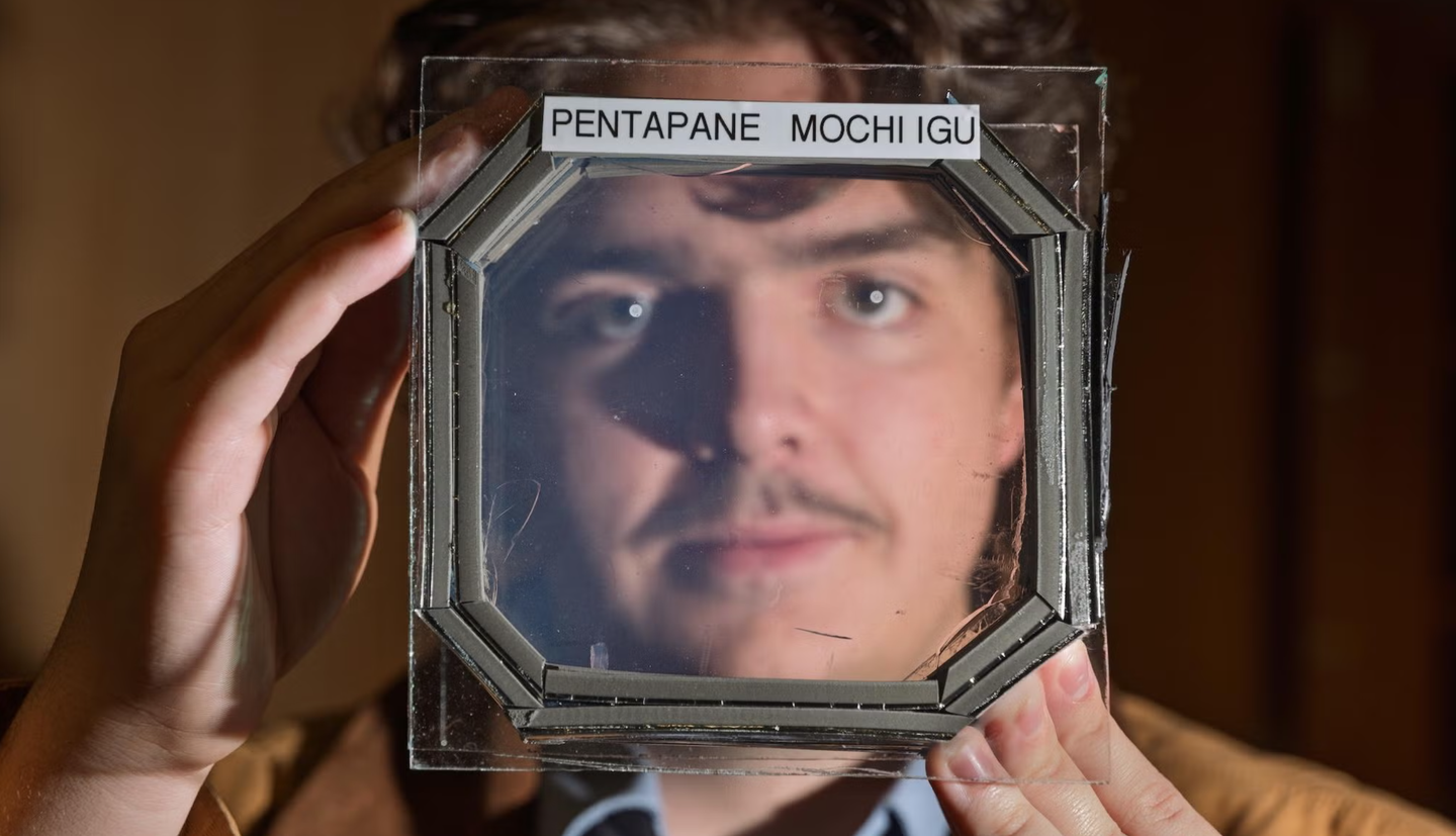 Abram Fluckiger, a CU Boulder undergrad, holds a block with five MOCHI layers sandwiched between two glass panes.