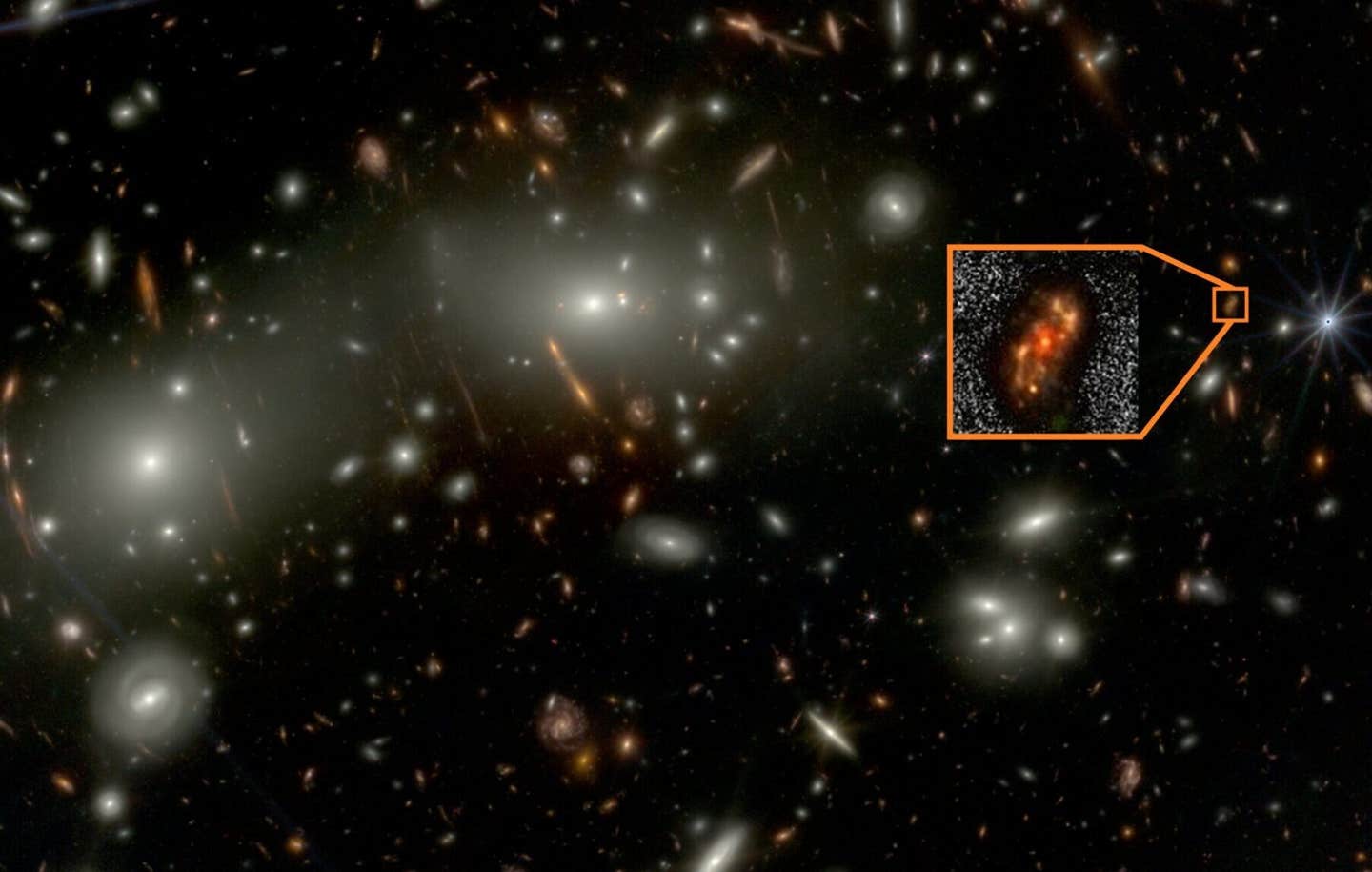 The newly identified spiral galaxy Alaknanda, shown in the inset, appears in shorter-wavelength observations from the James Webb Space Telescope. Bright foreground galaxies from the Abell 2744 cluster are also visible in the same field.